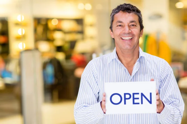 Business owner with an open sign