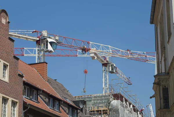 Cranes above buildings
