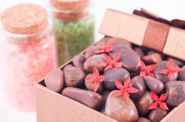 Red zen stones in a bronze gift box with red flowers and bath salts