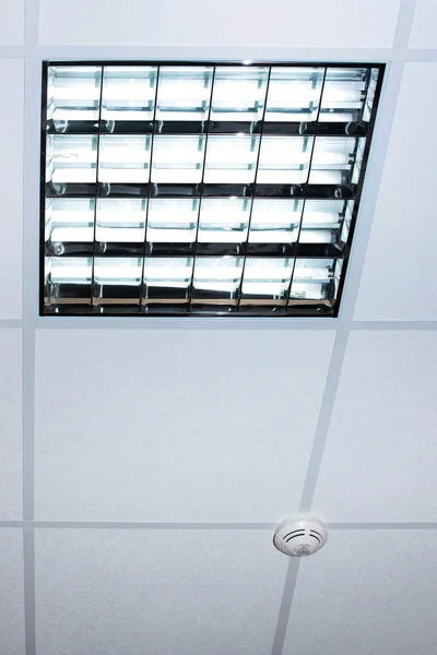 Fluorescent lamp on the modern office ceiling