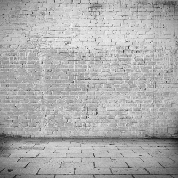 Grunge background white brick wall texture and blocks road sidewalk abandoned building exterior urban background for your concept or project