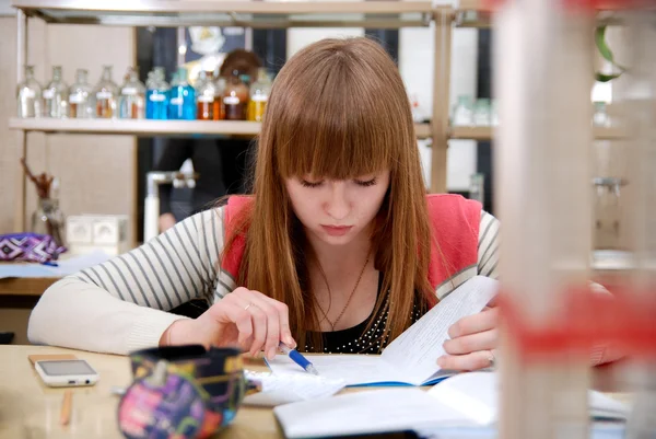 A student at work in laboratory of chemistry studies the records