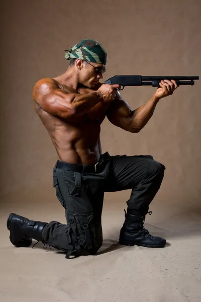 Strong athletic man with a gun. Special Forces soldier
