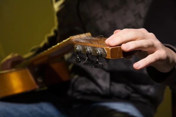 Close-up of a man with a guitar.