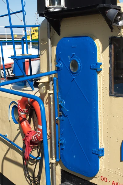 Blue hatch (door) on a fishing ship.