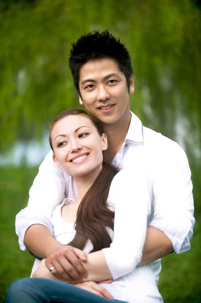 Asian couple hugging in the park
