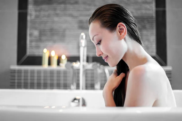 Attractive Mixed Asian Female relaxing and enjoying hair wash in the bath — Stock Photo #20975503