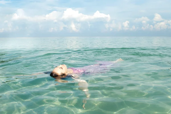 Attractive Asian Woman Floating in the Ocean