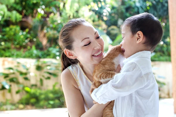 Asian mother with son and cat