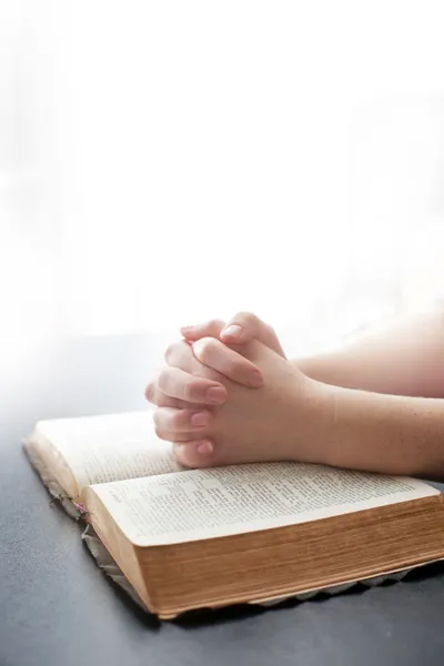 Woman praying on white background