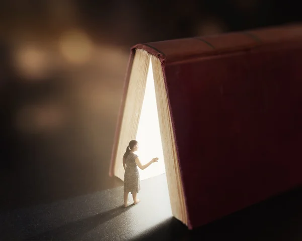 Glowing book with woman.