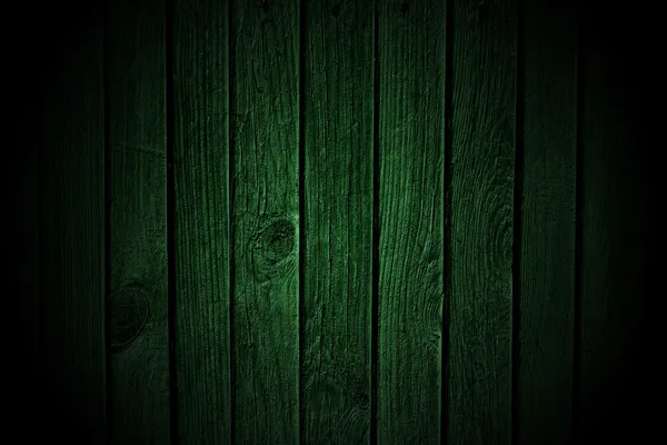 Wooden fence background in dark green tones