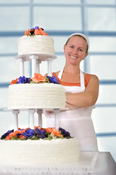 Happy Baker Lady smiling infront of her Ruffled Wedding Cake