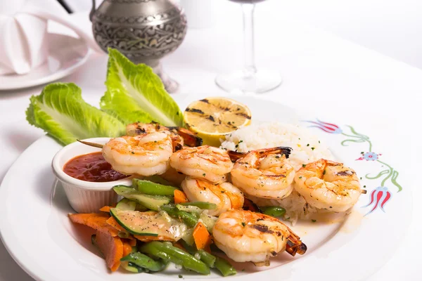 Shrimp Skewers are Grilled and Served with Veggies and Rice