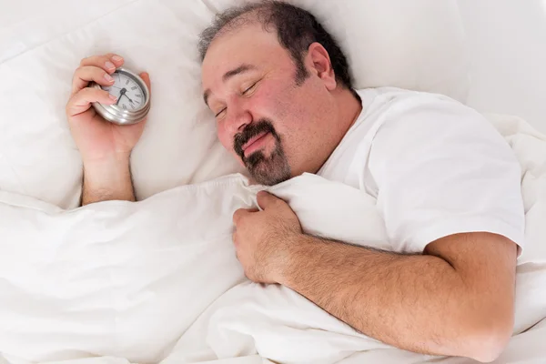 Man smiling in contentment after a good sleep