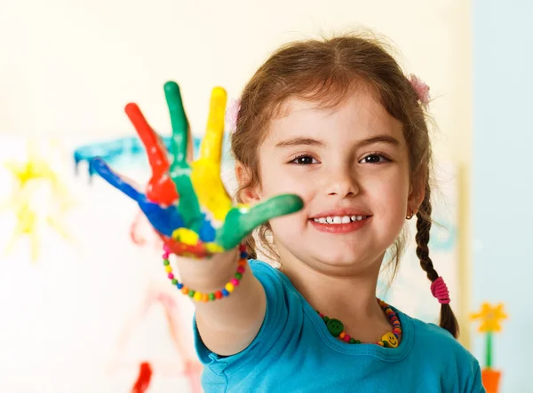 Happy child with painted hands