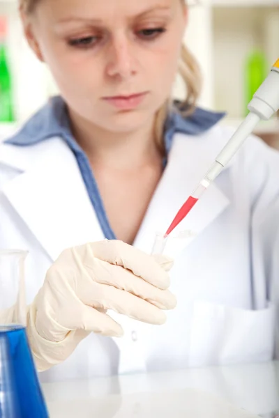 Female tech or scientist works with pipette in biological labora