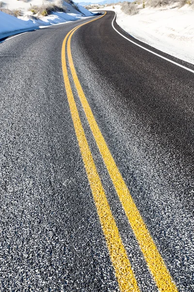 Yellow dividing line on asphalt road