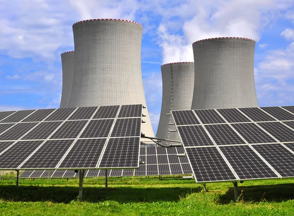 Solar energy panels before a nuclear power plant