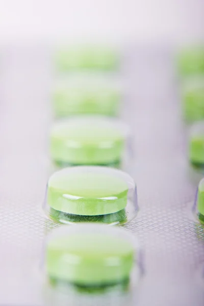 The row of green pills in a transparent package