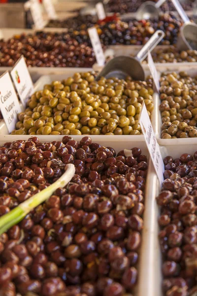 Eco-friendly products on a market stall . Various kinds of pickled olives