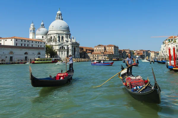Venice, Italy, Tourists ride on a gondola through a channel