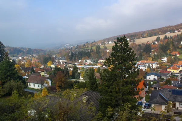Austria. View from the window of the going train on the foothills of the Alps in the foggy autumn afternoon