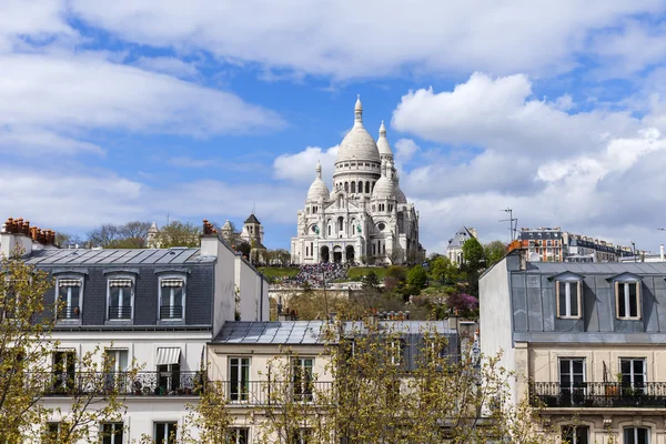 Paris, France, on April 29, 2013. View of Montmartre and cathedral Sakre-Ker from a house window in the sunny spring afternoon