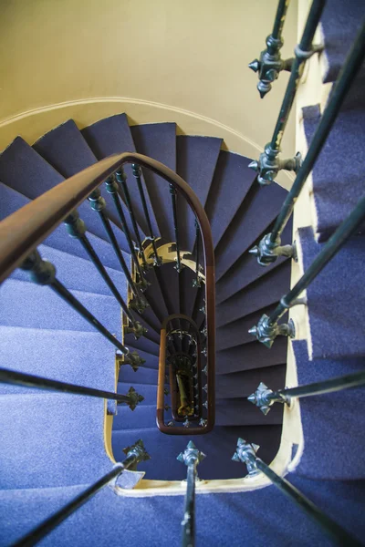 A spiral staircase between floors in an old house