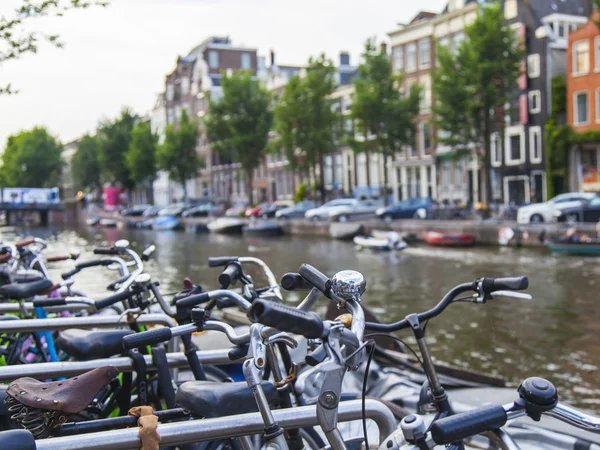 Amsterdam, Netherlands, on July 7, 2014. Bicycles on the bank of the channel. The bicycle is very popular type of transport in Holland