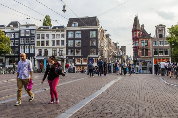 Amsterdam, Netherlands, on July 7, 2014. Tourists and citizens go down the street