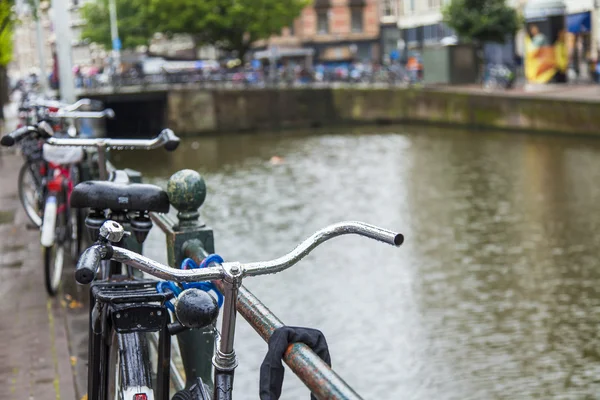 Amsterdam, Netherlands, on July 7, 2014. Bicycles on the bank of the channel. The bicycle is very popular type of transport in Holland