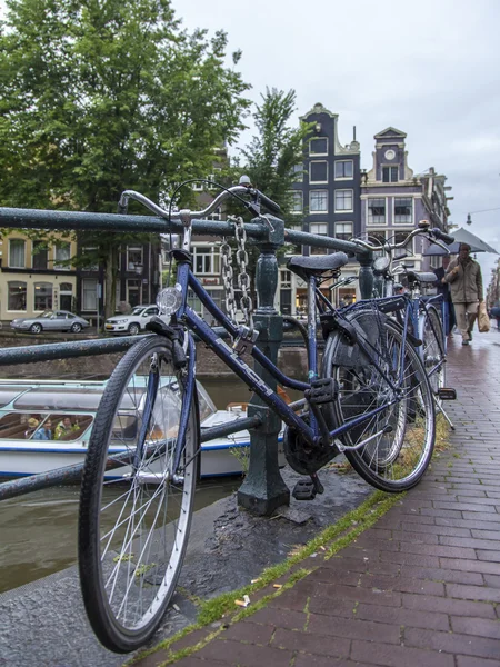 Amsterdam, Netherlands, on July 7, 2014. Bicycles on the bank of the channel. The bicycle is very popular type of transport in Holland