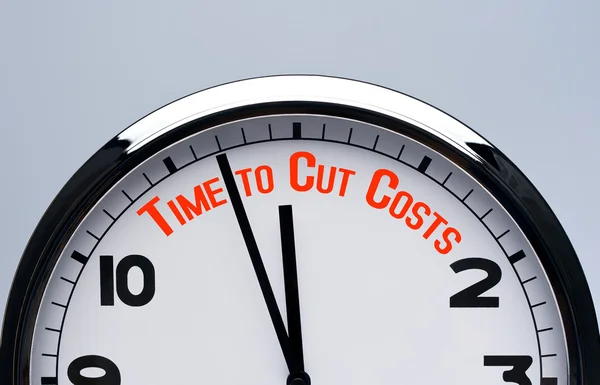 Clock with words time to cut costs. time to cut costs concept.