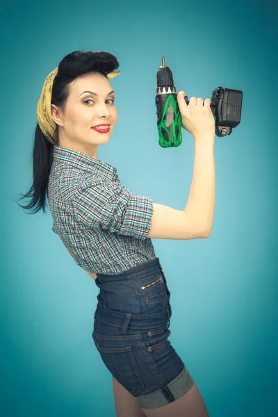 Picture of beautiful pin up woman with tool