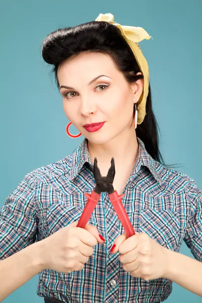 Girl in check shirt with pliers