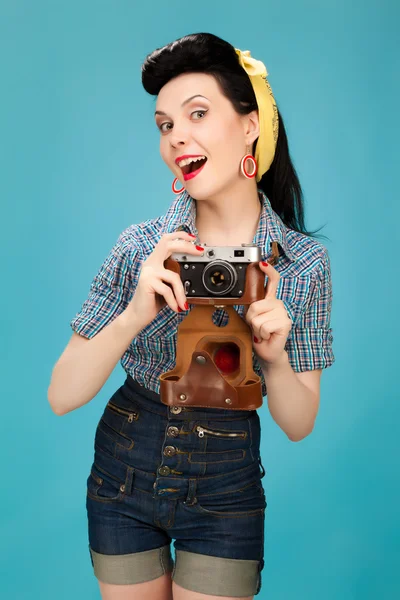 Retro pin-up woman with film camera