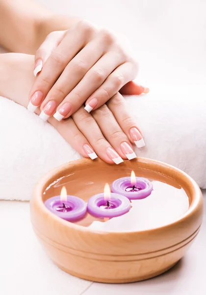 French manicure with aromatic candles and towel. Spa