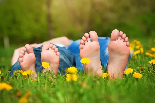 Feet on grass. Family picnic in green park