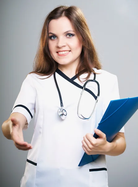 Attractive young nurse. Holds a blue folder and gives a hand for