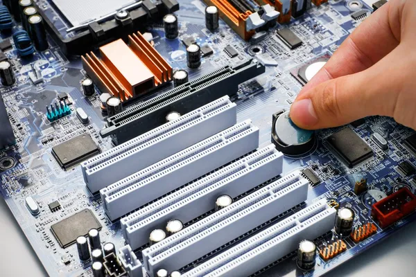 Hand install battery to PC motherboard — Stock Photo #32750983