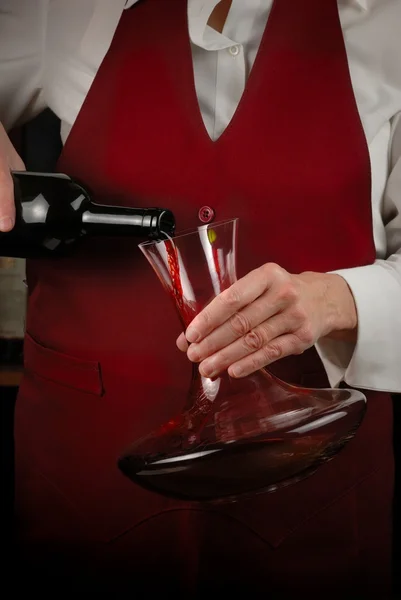 Sommelier pouring red wine