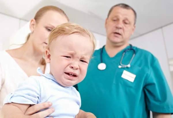 Boy is frightened and crying in a medical study.