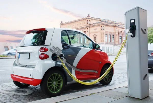 Electro car is charging on the street.