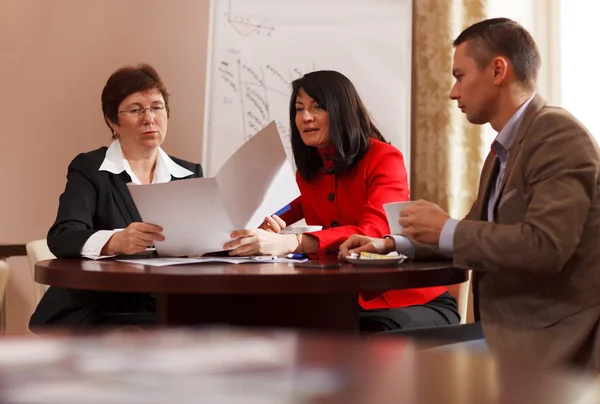 Businesspeople having a meeting over coffee