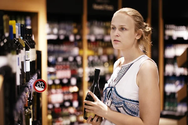 Woman shopping for alcohol in a bottle store