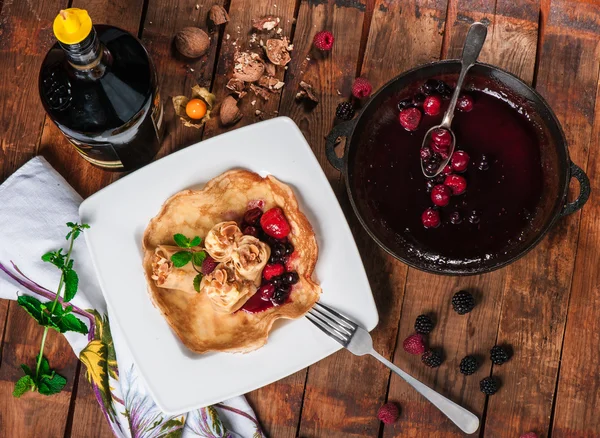 Rolled pancakes with berry jam