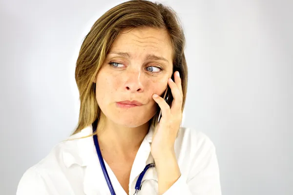 Scared female doctor on the phone