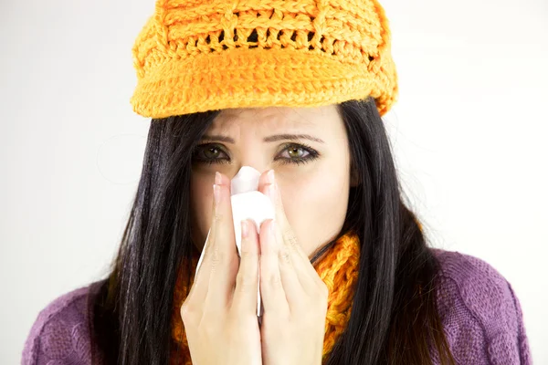 Sick woman blowing handkerchief