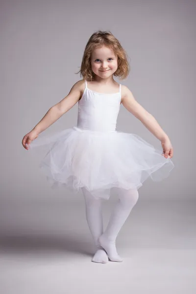 Happy little girl in dress ballerina